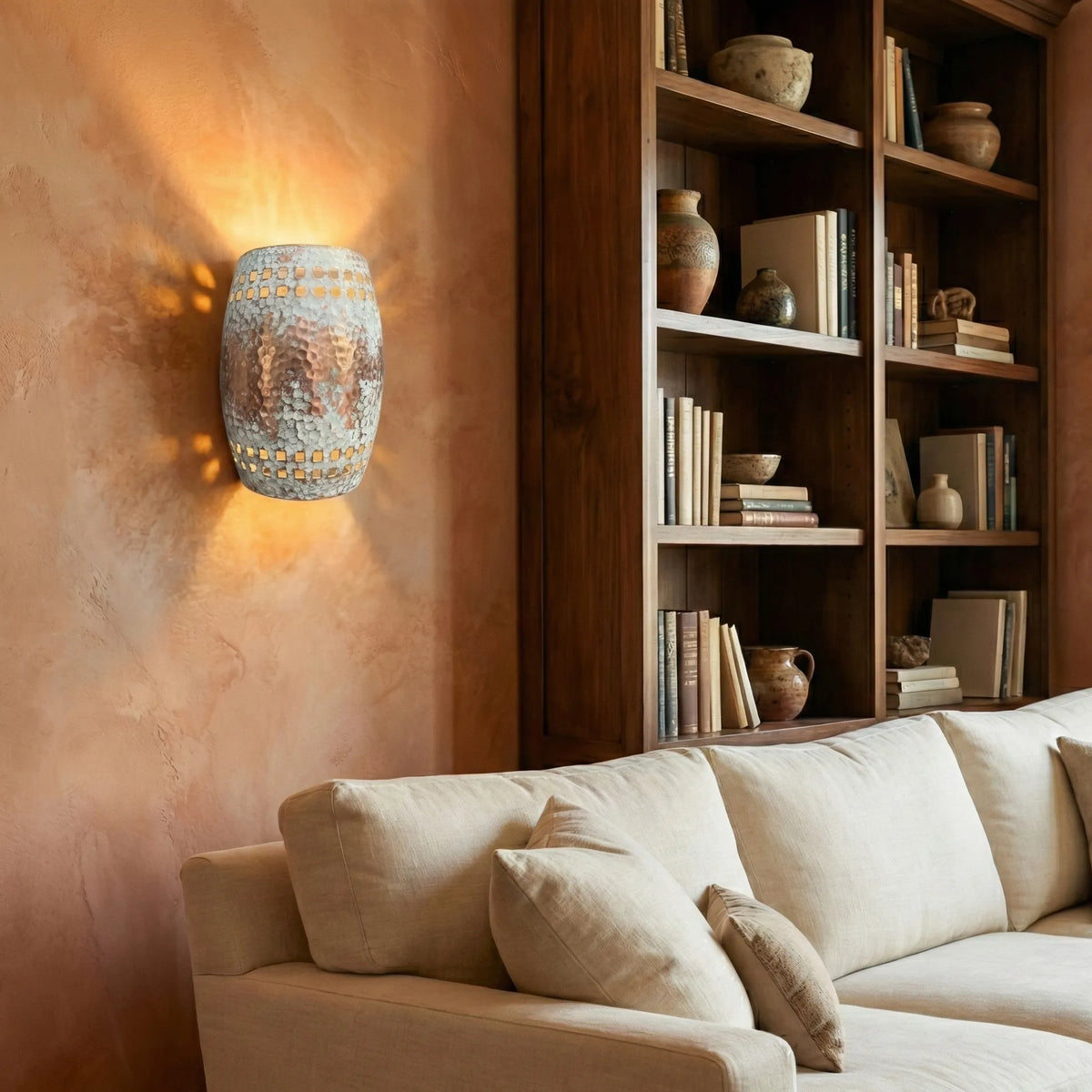 Copper sconce above a sofa in a living room