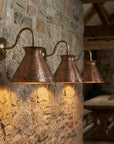Rustic vintage copper wall light fixture with warm interior glow