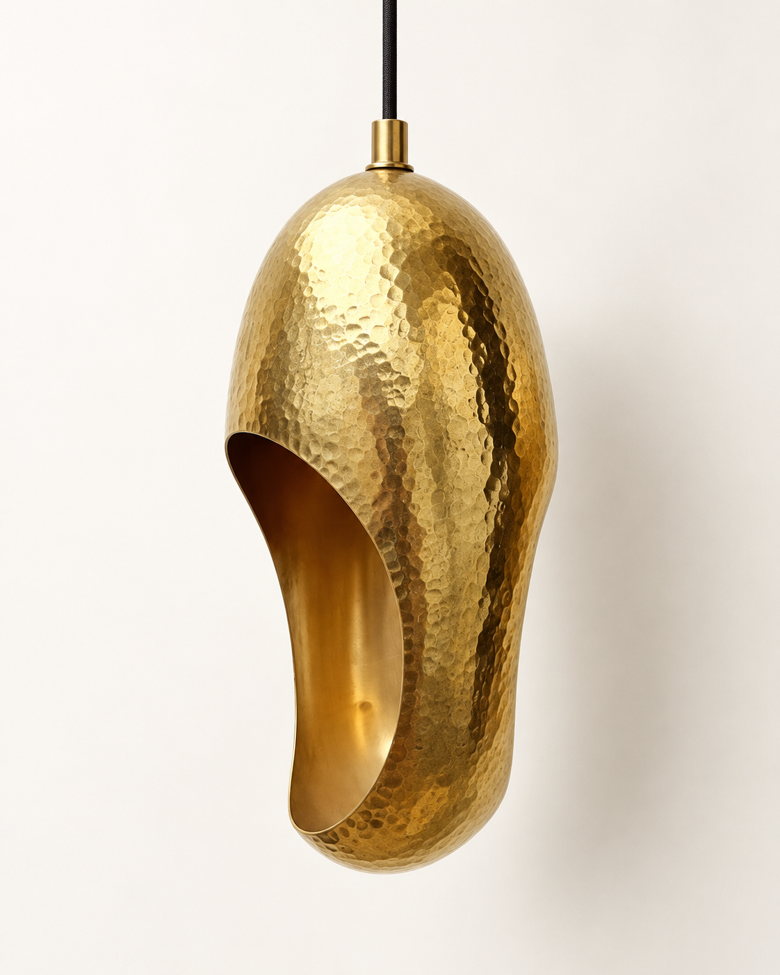 Close-up of one hammered solid brass sculptural pendant light
