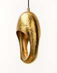 Hammered solid brass sculptural pendant light on a clean studio background