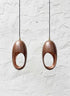 Set of two hammered aged-copper sculptural pendant lights