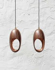 Set of two hammered aged-copper sculptural pendant lights