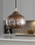 Aged-copper dome pendant light in a contemporary kitchen