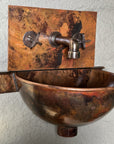 Detailed view of handcrafted hammered copper wall-mount sink
