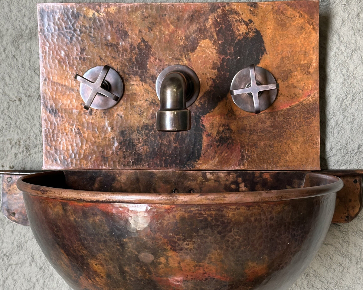 Wall-mounted copper bathroom basin with backsplash and mixer faucet