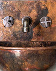 Wall-mounted copper bathroom basin with backsplash and mixer faucet